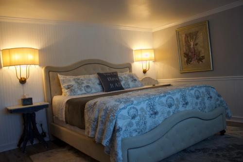 a bedroom with a large bed with two lamps at Dungeness Barn House Bed and Breakfast at Two Crows Farm in Sequim
