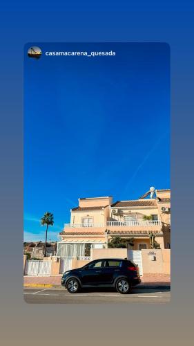 a black car parked in front of a building at Luxury Holiday Townhouse with Pool II Casa Macarena 02 in Ciudad Quesada