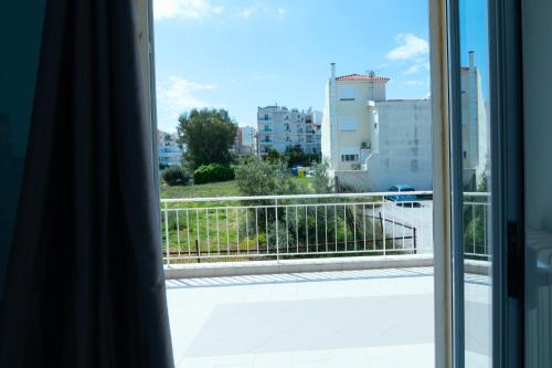 a view from the window of a balcony at The Sunrise Apartment By Athens Airport 1 in Spáta