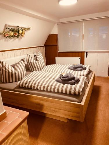 a bedroom with a bed with two pillows on it at Ferienhaus Lichtblick in Kurort Gohrisch