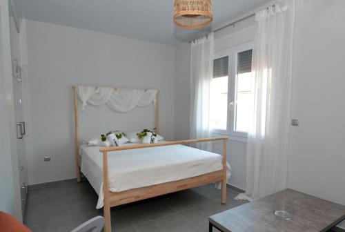 a bedroom with a bed and a window at IRON House in Kavála