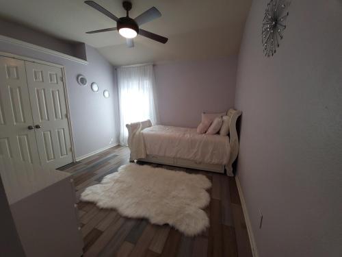 a living room with a couch and a ceiling fan at Lovely Lakeside Living in Rockwall