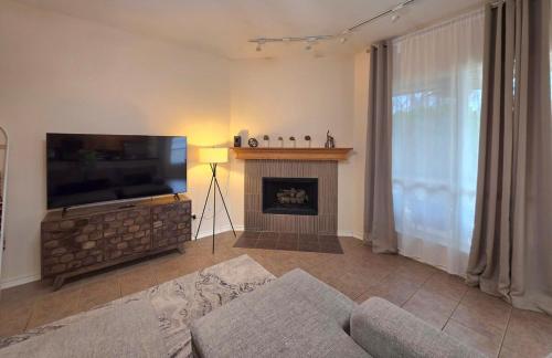 a living room with a flat screen tv and a fireplace at Lovely Lakeside Living in Rockwall