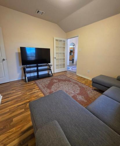 a living room with a couch and a flat screen tv at Lovely Lakeside Living in Rockwall