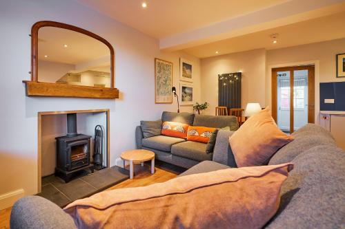 a living room with a couch and a fireplace at Blairgowrie - Cosy terraced cottage sleeps 4 in Blairgowrie