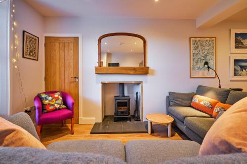 a living room with a couch and a fire place at Blairgowrie - Cosy terraced cottage sleeps 4 in Blairgowrie