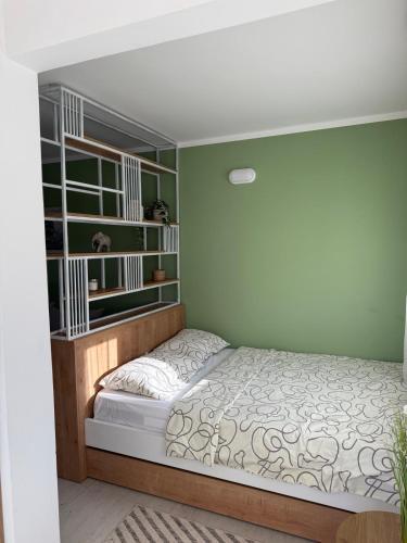 a bedroom with a bed and book shelves at Sanja apartman in Bar