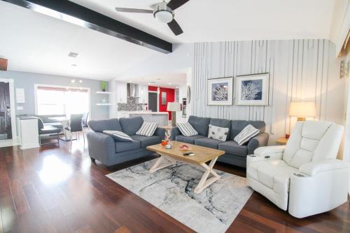 a living room with a couch and a table at Chic 3 BR Private Pool Home in Lehigh Acres in Lehigh Acres