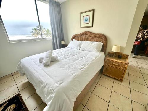 a bedroom with a large white bed with a window at Boulevard Margate in Margate