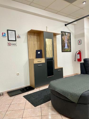 a bedroom with a bed and a desk with a computer at Apartman ROYAL in Sanski most
