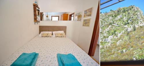 a bedroom with a bed and a view of a mountain at Stylish apartment 22 in Kotor