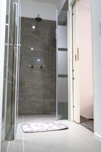 a shower in a bathroom with a glass door at Bellinzona Boutique in Buenos Aires