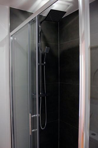 a shower with a glass door in a bathroom at Modern City Centre Apartment - Sleeps 4 - ideal for families, couples & professionals in Leicester