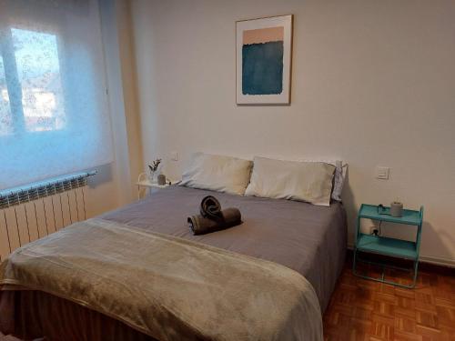 a bed with a stuffed animal sitting on top of it at Vida Boa in El Dueso