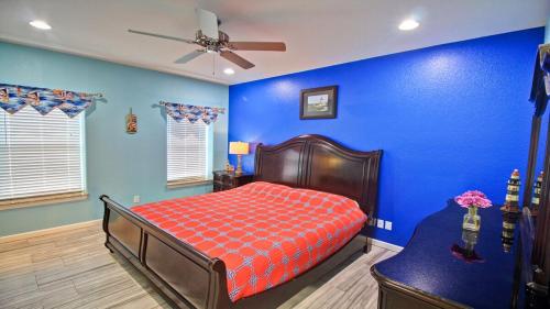 a blue bedroom with a bed and a ceiling fan at 100Ft To Beach,Beachview,EV charger,Heated Pool,Jacuzzi in South Padre Island