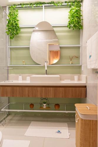 a bathroom with a sink and a mirror at Mansão pontal beach in Pontal