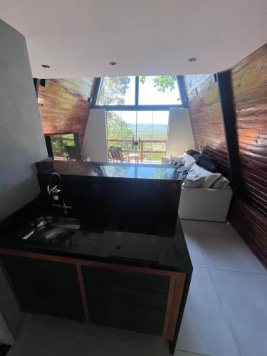 a bathroom with a sink and a large window at Lumiar Cabanas in Rio de Janeiro