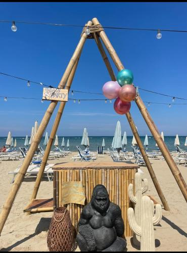 a statue of a gorilla sitting on a beach at Appartamento Vacanze ACQUA E SALE in Marotta