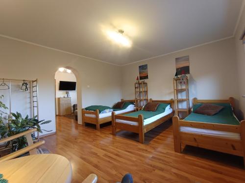 a living room with three beds and a table at Agroturystyka u Bartka in Kamienna Góra