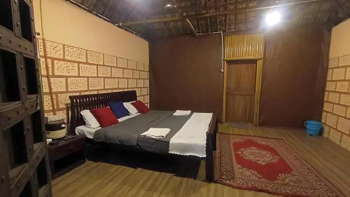a bedroom with a bed and a door in it at Brook Ville in Sasan Gir
