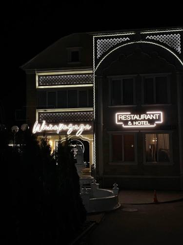 a restaurant with a sign in front of a building at Шахерезада in Vinnytsya
