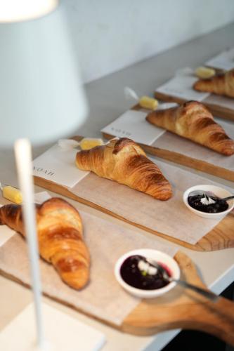 a table topped with pastries and other dishes of food at âmé by NOAH in Cape Town