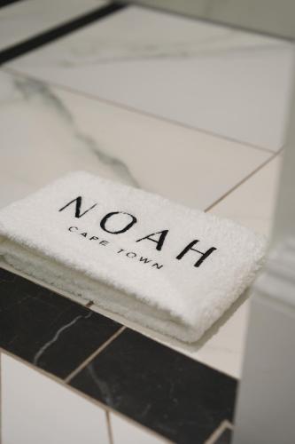 a white napkin with the word vaan on it at âmé by NOAH in Cape Town
