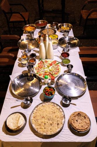 a table with many different types of food on it at Brook Ville in Sasan Gir