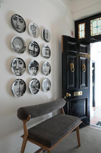 a room with black and white plates on the wall at âmé by NOAH in Cape Town