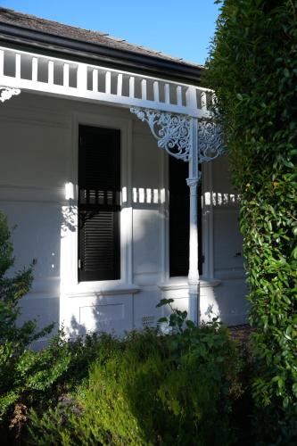 a white house with a window and a pole at âmé by NOAH in Cape Town