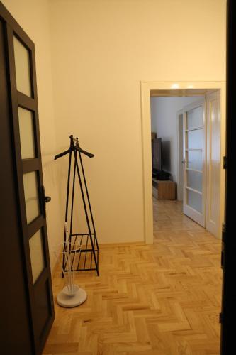 a room with a wooden floor and a tripod in a room at DM apartman in Osijek