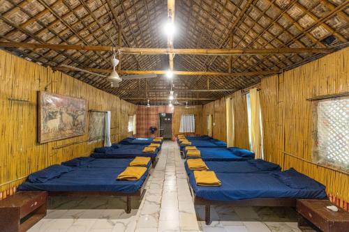 a row of beds lined up in a room at Brook Ville in Sasan Gir