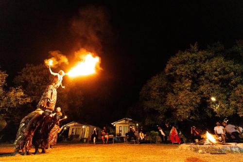 a statue of a person on an elephant with a fire at Brook Ville in Sasan Gir