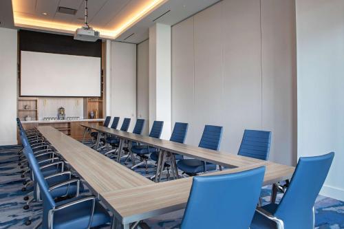 a conference room with a long table and blue chairs at The Royal Sonesta Washington DC Capitol Hill in Washington