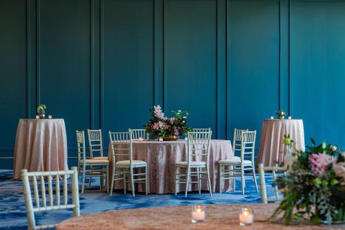 a group of tables and chairs with flowers on them at The Royal Sonesta Washington DC Capitol Hill in Washington