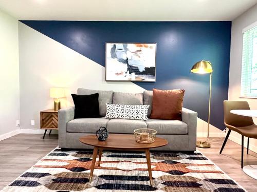 a living room with a couch and a table at Downtown-King Bed-Top Floor-Parking-Wi-Fi in Walnut Creek