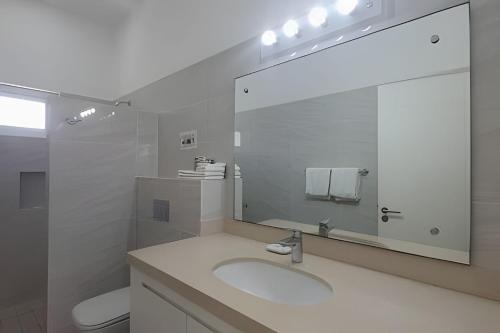 a bathroom with a sink and a large mirror at Departamento Hanna #3 Bucerias in Bucerías