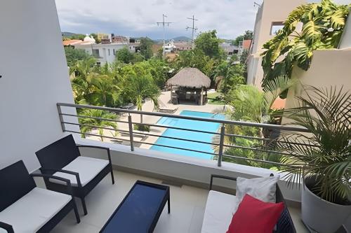 a balcony with a view of a swimming pool at Departamento Hanna #3 Bucerias in Bucerías