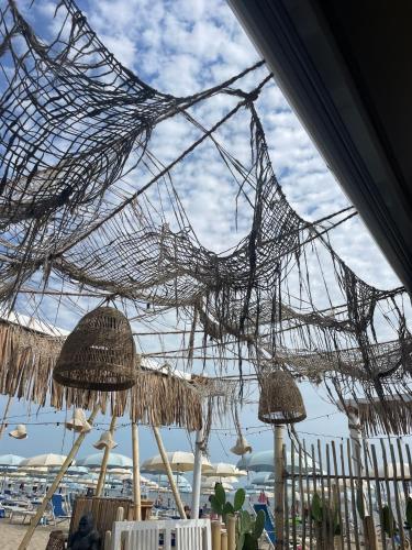 a bunch of nets hanging from a ceiling at Appartamento Vacanze ACQUA E SALE in Marotta