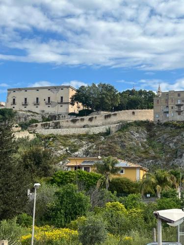 a building on the side of a hill with houses at Terra del Gattopardo in Palma di Montechiaro
