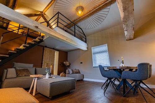 a living room with a loft with a staircase at Os Hoes 1851 in Nuth