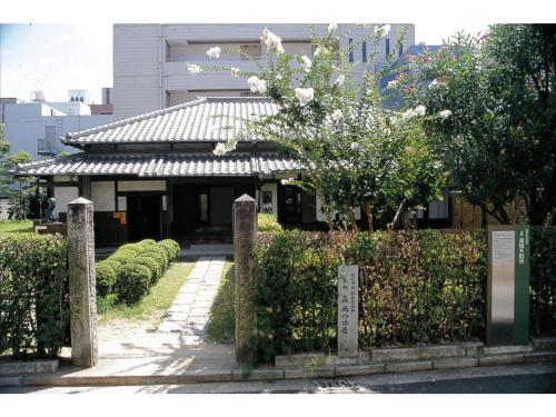 a building with a gate in front of a garden at Kokura Recent Hotel - Vacation STAY 61113v in Kitakyushu