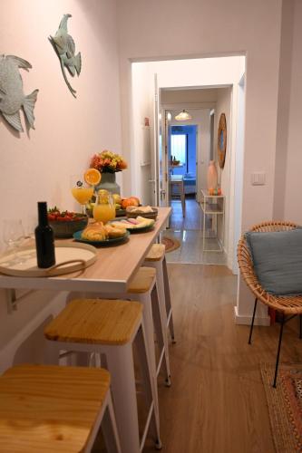 a dining room with a table with fruits on it at Downtown Lovely in Vila Real