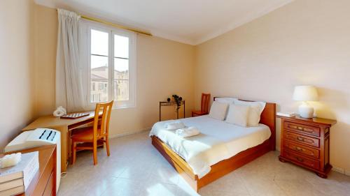 une chambre avec un lit, un bureau et une fenêtre dans l'établissement 3 Bedroom flat, 50 metres from Monaco!, à Beausoleil