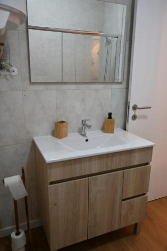 a bathroom with a sink and a mirror at Downtown Lovely in Vila Real