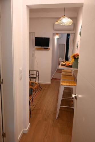 a hallway with a table and a dining room at Downtown Lovely in Vila Real
