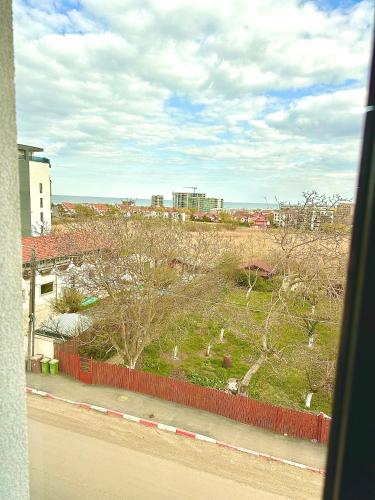 a view of a field from a window of a building at North Boutique Apartments in Mamaia Nord
