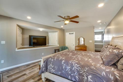 a bedroom with a bed and a ceiling fan at Spacious Lake of the Ozarks Escape with Deck and Views in Linn Creek