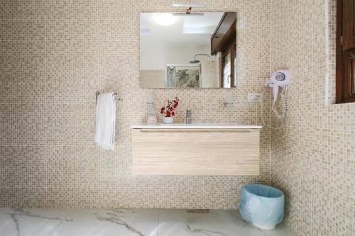 a bathroom with a sink and a mirror at Residence Speedy Lovely Suites - 9 Appartamenti Fino a 52 Ospiti - Fiumicino Airport in Fiumicino