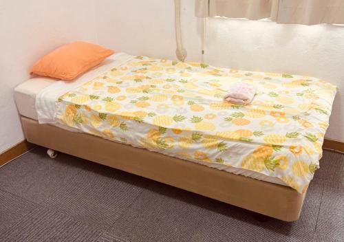 a bed with a blanket on top of it at Minshuku Fugarassa - Vacation STAY 81579v in Ishigaki Island